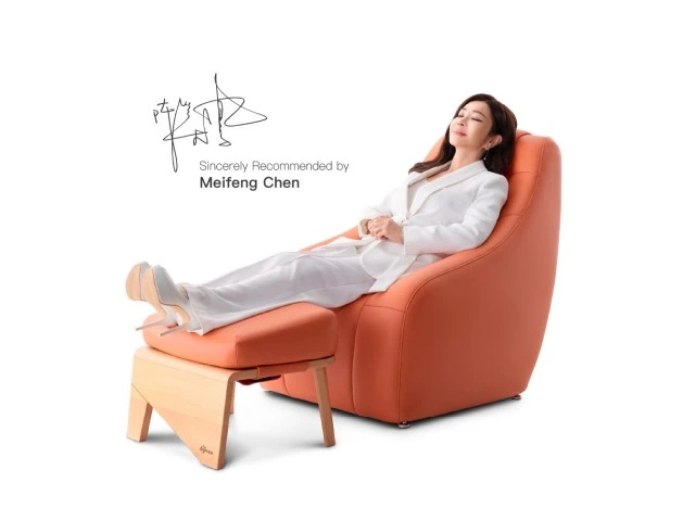 Celebrity Meifeng Chen relaxing in an orange BGREEN vibration chair with a matching ottoman, showcasing professional endorsement of passive exercise wellness technology