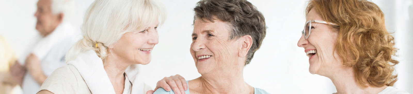 Three senior women smiling and enjoying exercise together